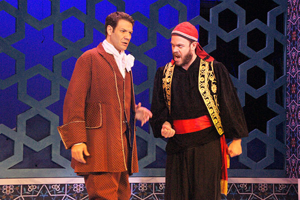 Two men in costume acting on stage