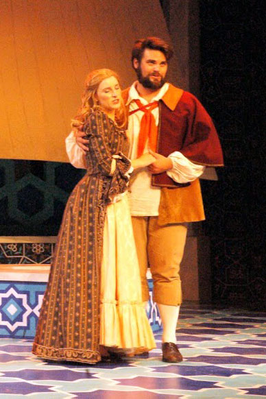 two theater actors on stage in their costumes