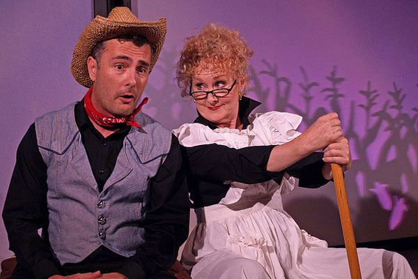 a man and a woman in costumes sitting down