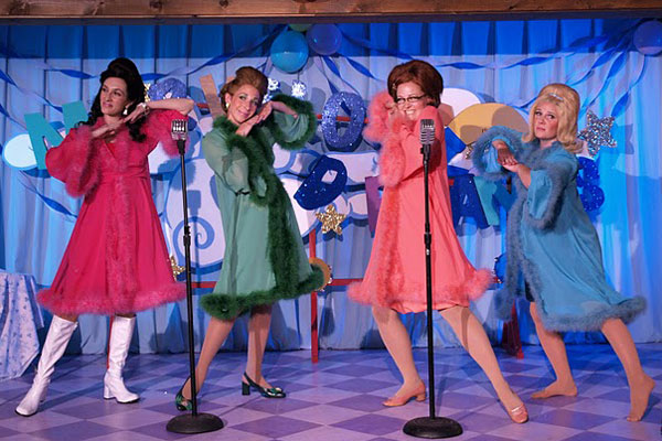 four women in different colored costumes